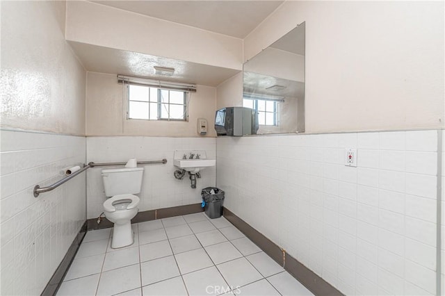 bathroom featuring tile walls, toilet, tile patterned floors, and sink