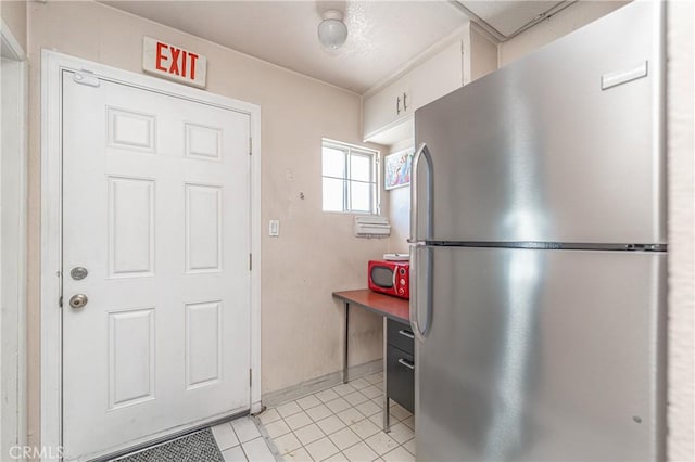 kitchen with stainless steel fridge and light tile patterned floors