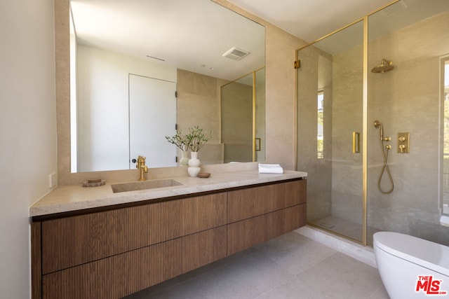 bathroom featuring toilet, a shower with door, tile patterned floors, and vanity