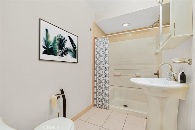 bathroom with walk in shower, tile patterned flooring, and toilet