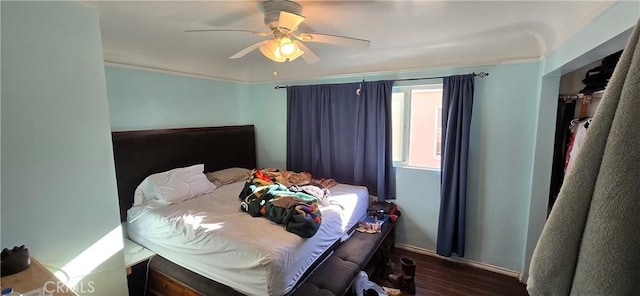 bedroom featuring ceiling fan and dark wood-type flooring