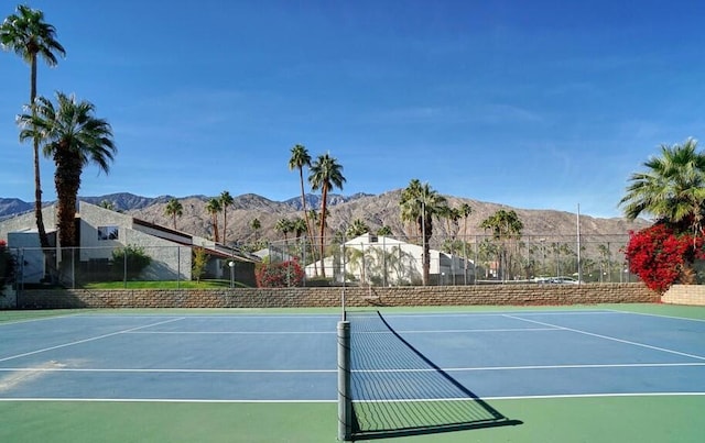 view of tennis court featuring basketball court and a mountain view