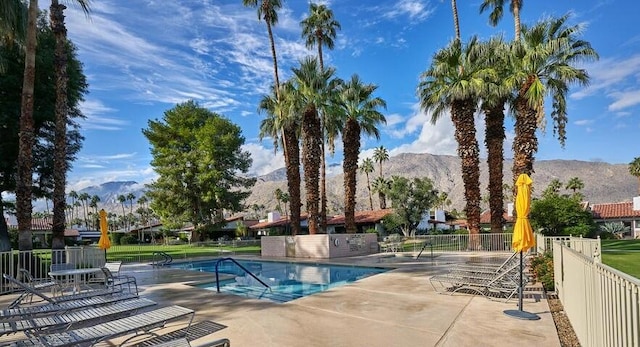 view of swimming pool featuring a patio and a mountain view