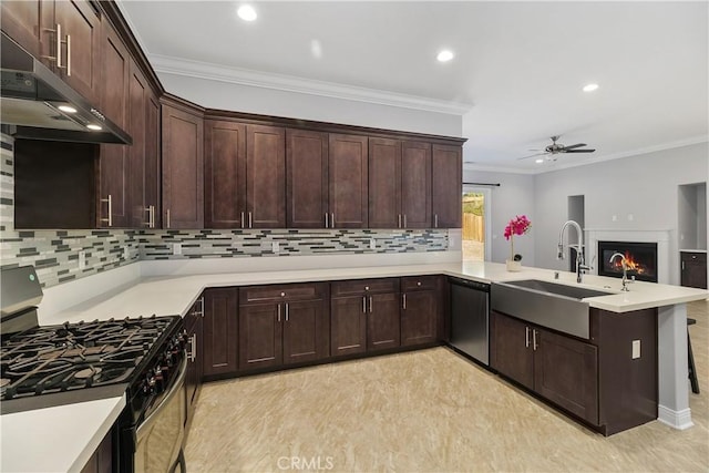 kitchen with kitchen peninsula, dishwasher, gas stove, ceiling fan, and sink