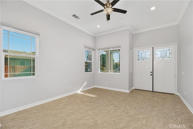 spare room with ceiling fan, ornamental molding, and plenty of natural light