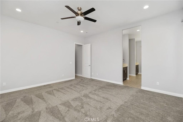 unfurnished room featuring ceiling fan and light carpet