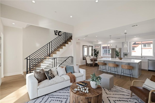 1700 Perkins Ln, Redondo Beach, CA 90278 - living area featuring stairs, light wood finished floors, healthy amount of natural light, and recessed lighting