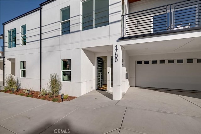 exterior space featuring a garage and a balcony