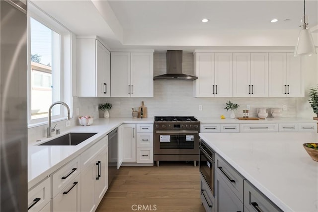 1700 Perkins Ln, Redondo Beach, CA 90278 - kitchen with wall chimney range hood, appliances with stainless steel finishes, light countertops, white cabinets, and tasteful backsplash