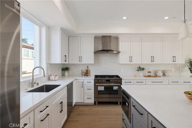 1700 Perkins Ln, Redondo Beach, CA 90278 - kitchen with wall chimney exhaust hood, stainless steel appliances, light countertops, white cabinets, and recessed lighting