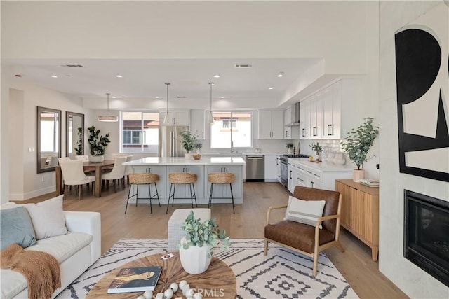 1700 Perkins Ln, Redondo Beach, CA 90278 - living area with light wood-style flooring, recessed lighting, and a large fireplace