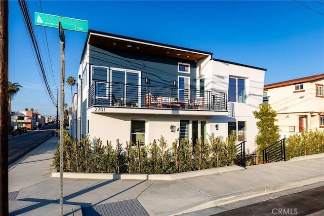1700 Perkins Ln, Redondo Beach, CA 90278 - view of front of house with stucco siding and a balcony
