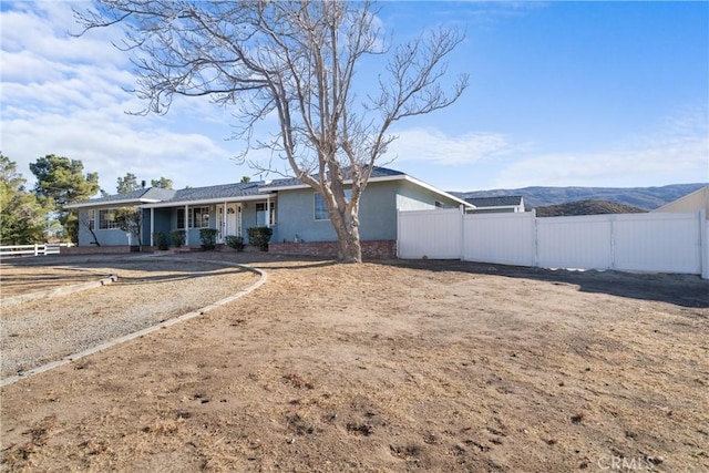 view of front of house with covered porch and a mountain view