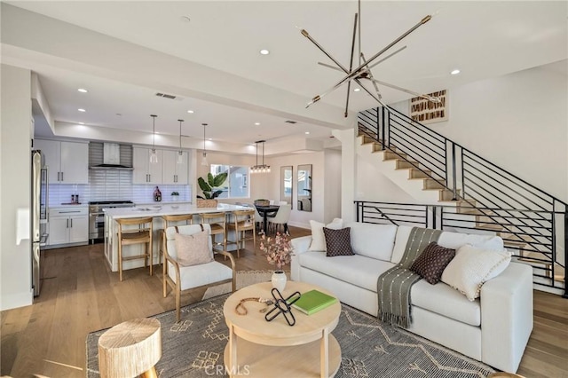 living room featuring hardwood / wood-style floors and an inviting chandelier