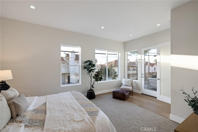 bedroom featuring light hardwood / wood-style floors and access to outside