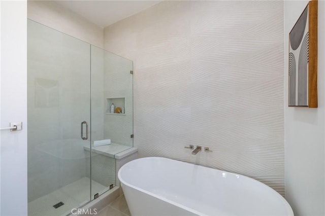 bathroom featuring shower with separate bathtub