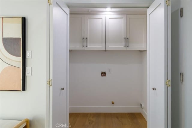 laundry room with light hardwood / wood-style floors