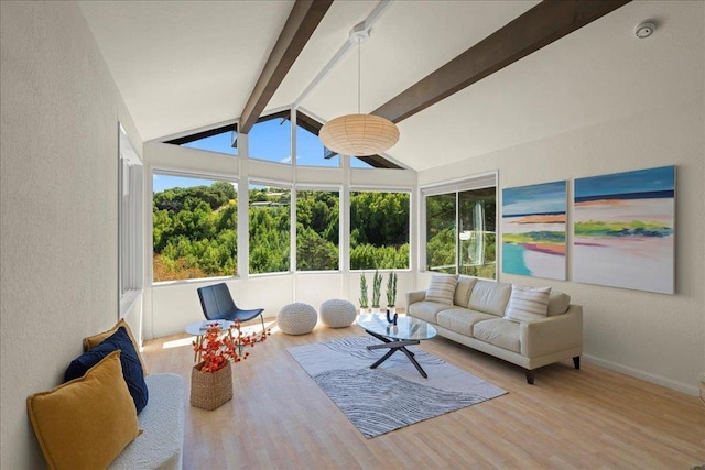 sunroom featuring vaulted ceiling with beams