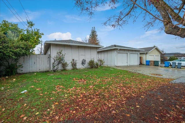 view of property exterior featuring a lawn and a garage