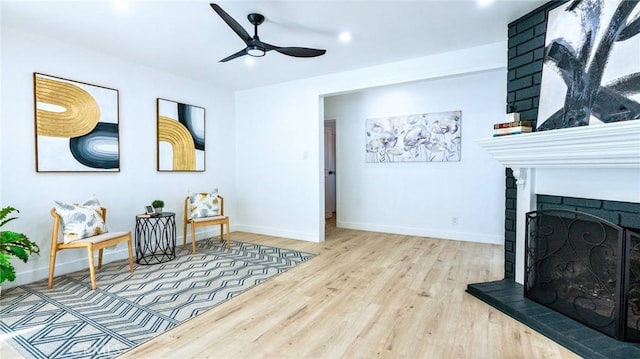 living area with light hardwood / wood-style flooring and ceiling fan