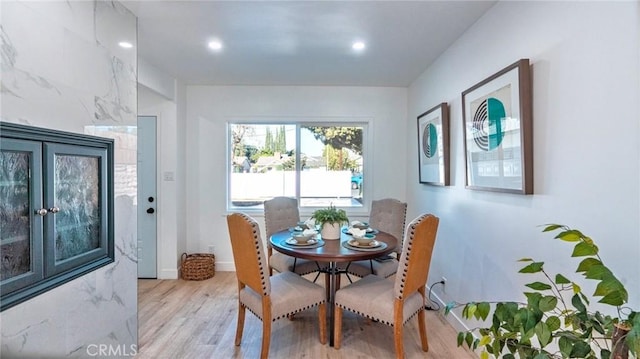 dining area featuring light hardwood / wood-style flooring and french doors