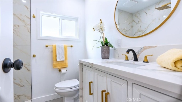 bathroom with walk in shower, vanity, and toilet