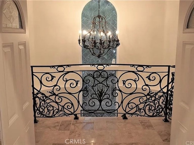 interior space featuring a chandelier and stone finish floor