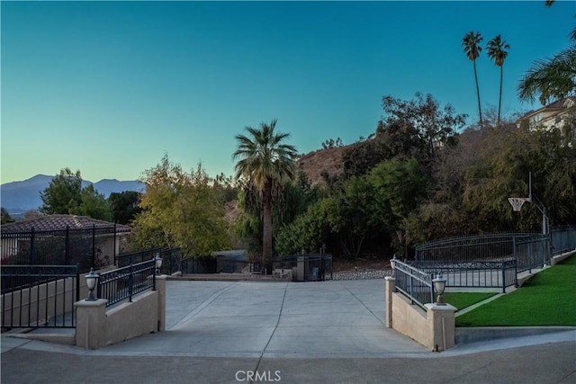 view of front facade with a mountain view and fence