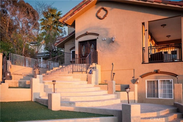 view of front of home featuring stairway and stucco siding