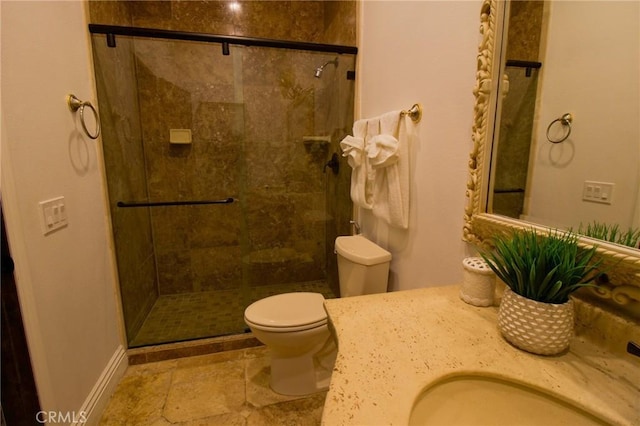 full bath with a sink, a shower stall, and toilet