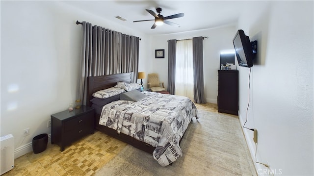 bedroom featuring baseboards, visible vents, and ceiling fan