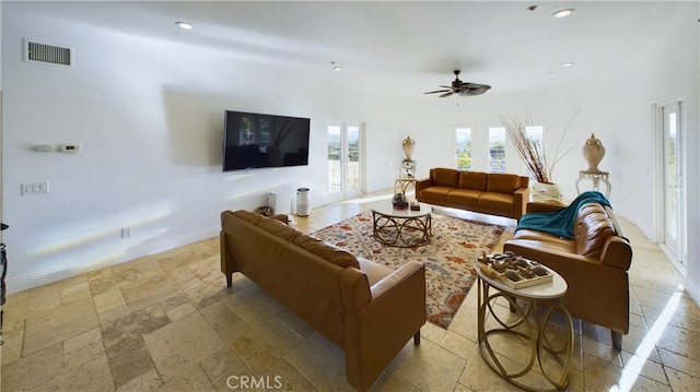 living area featuring recessed lighting, baseboards, visible vents, and stone tile floors