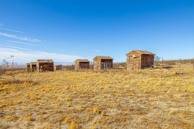 view of yard featuring a storage shed and a rural view