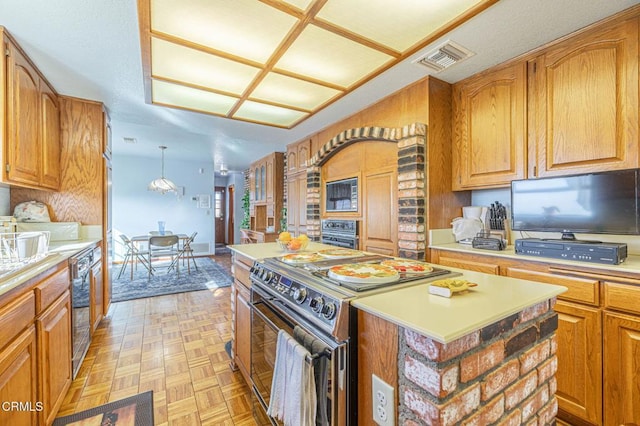 kitchen featuring light parquet flooring, a kitchen island, pendant lighting, and range