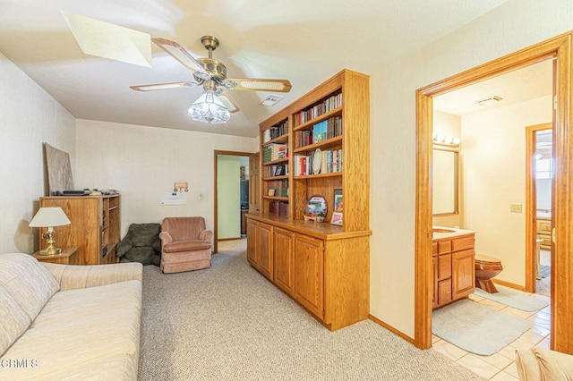 carpeted living room featuring ceiling fan