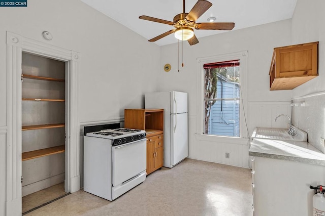 kitchen featuring sink, white appliances, and ceiling fan