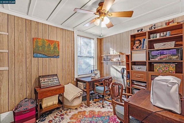 office space with ceiling fan and wooden walls