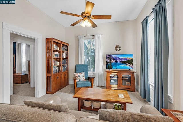 living area featuring ceiling fan and light colored carpet