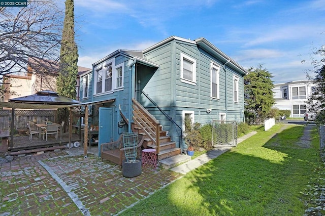 back of property featuring a patio area and a yard