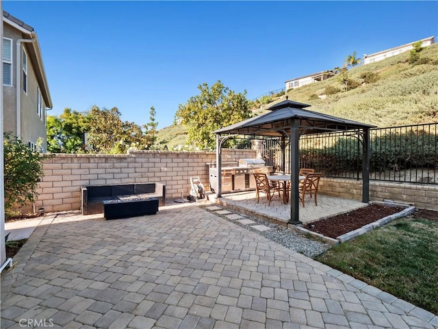 view of patio with a gazebo and a fire pit