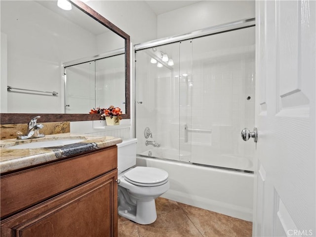 full bathroom with toilet, vanity, tile patterned floors, and combined bath / shower with glass door