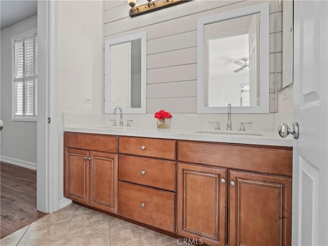 bathroom with vanity, wooden walls, and tile patterned floors