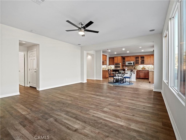 unfurnished living room with ceiling fan and dark hardwood / wood-style floors