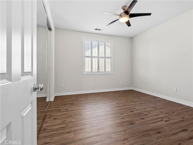 unfurnished room with ceiling fan and dark hardwood / wood-style floors