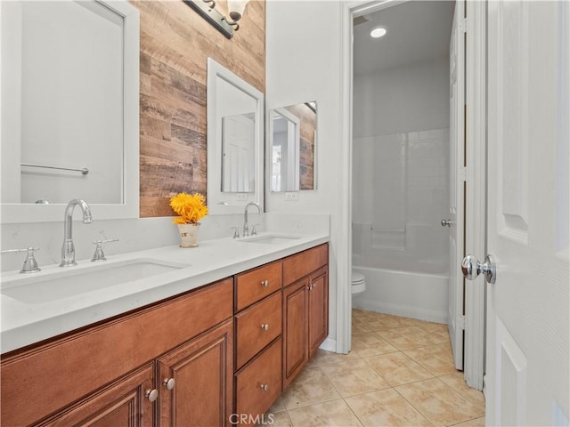 full bathroom with toilet, tub / shower combination, wooden walls, tile patterned floors, and vanity