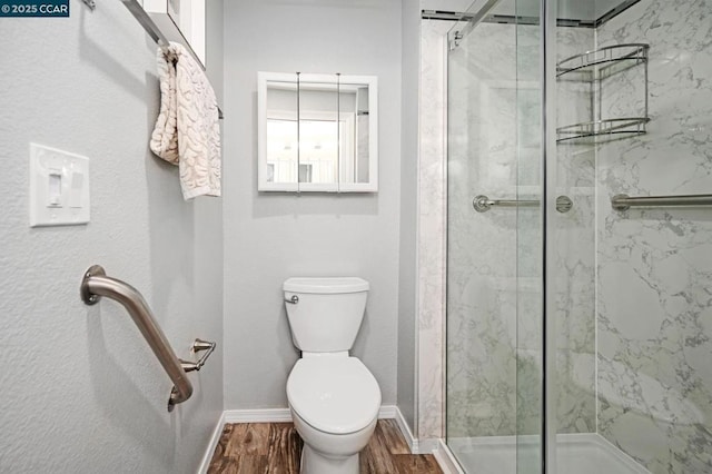 bathroom with wood-type flooring, toilet, and walk in shower