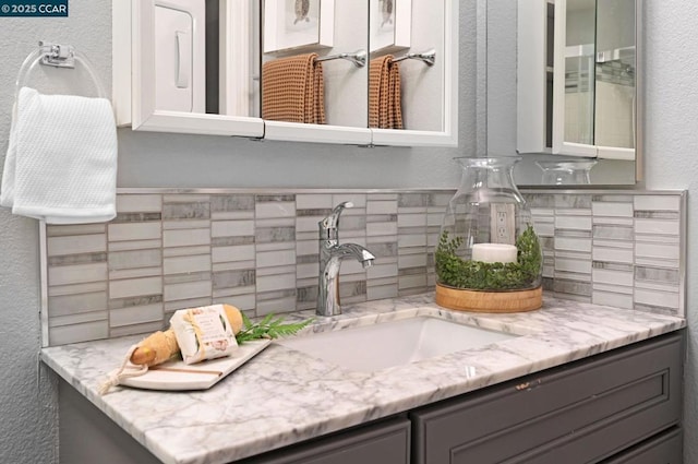 bathroom featuring decorative backsplash and vanity