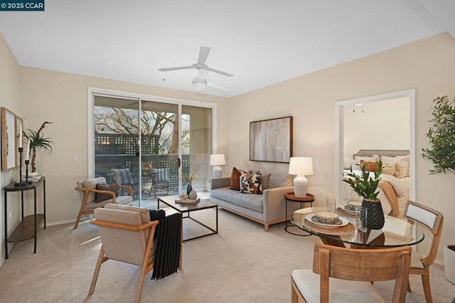 carpeted living room with ceiling fan