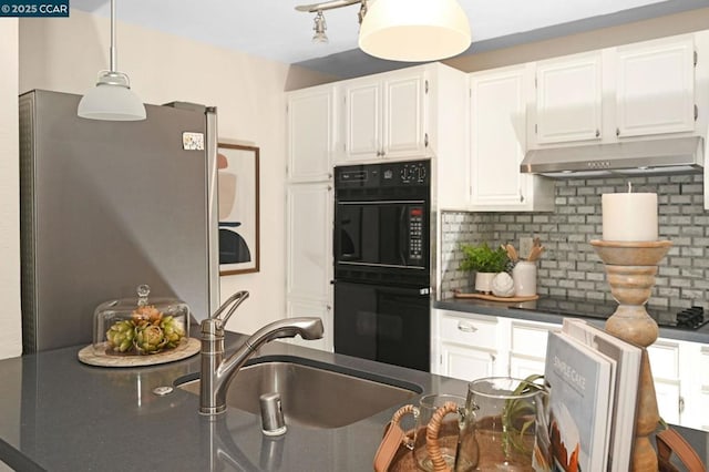 kitchen with decorative backsplash, hanging light fixtures, white cabinets, and black appliances