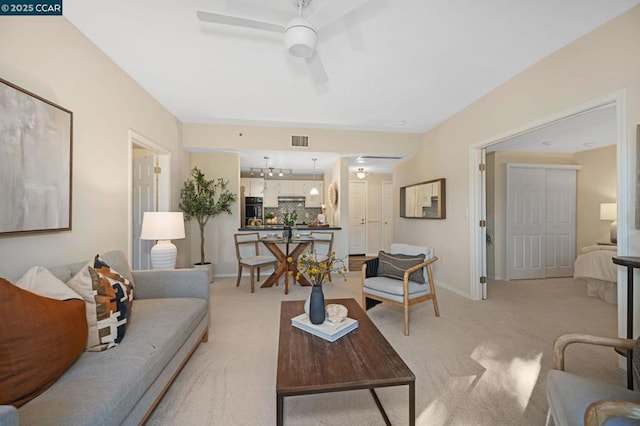 carpeted living room featuring ceiling fan